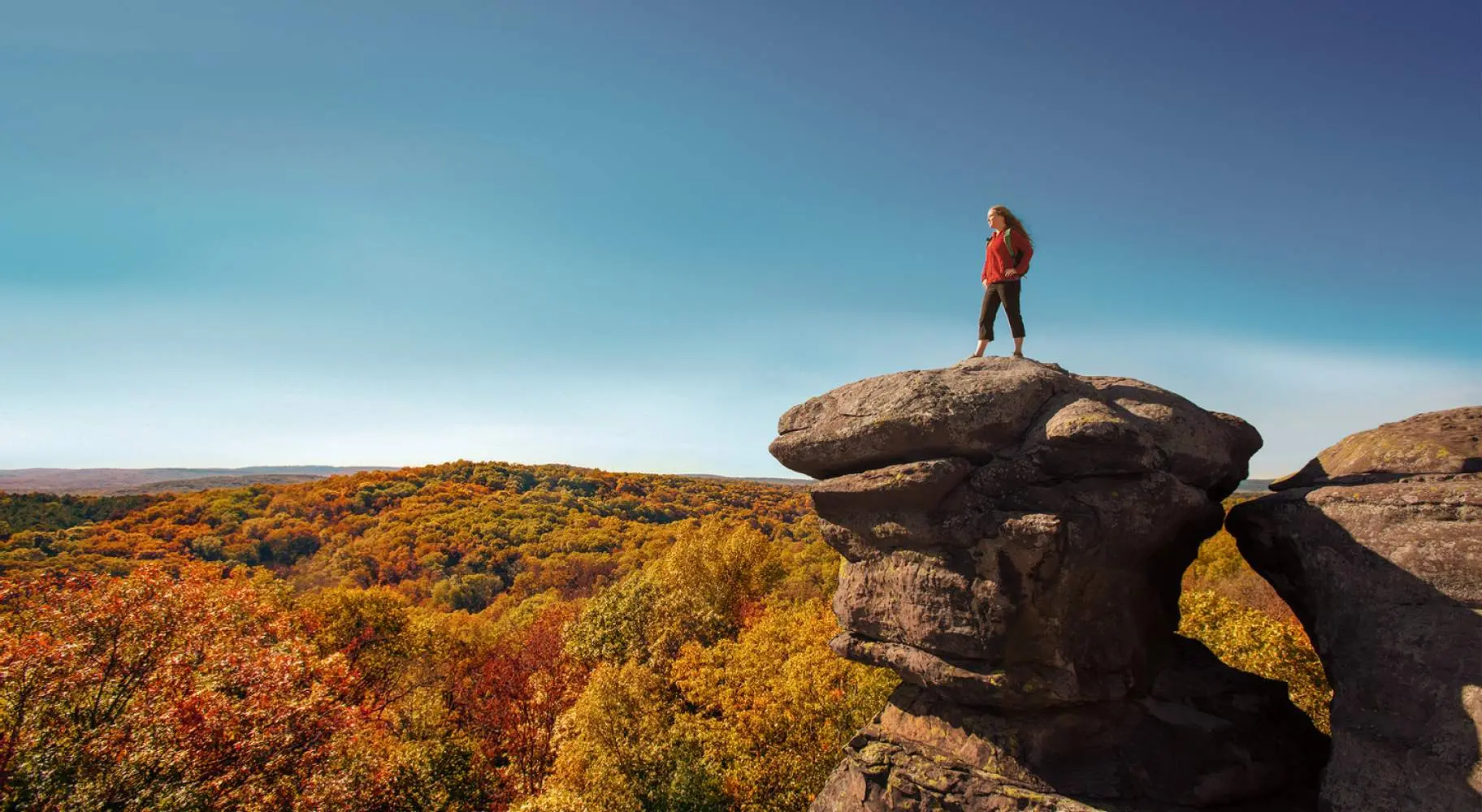 A hiker overlooking fall colors at Garden of the Gods